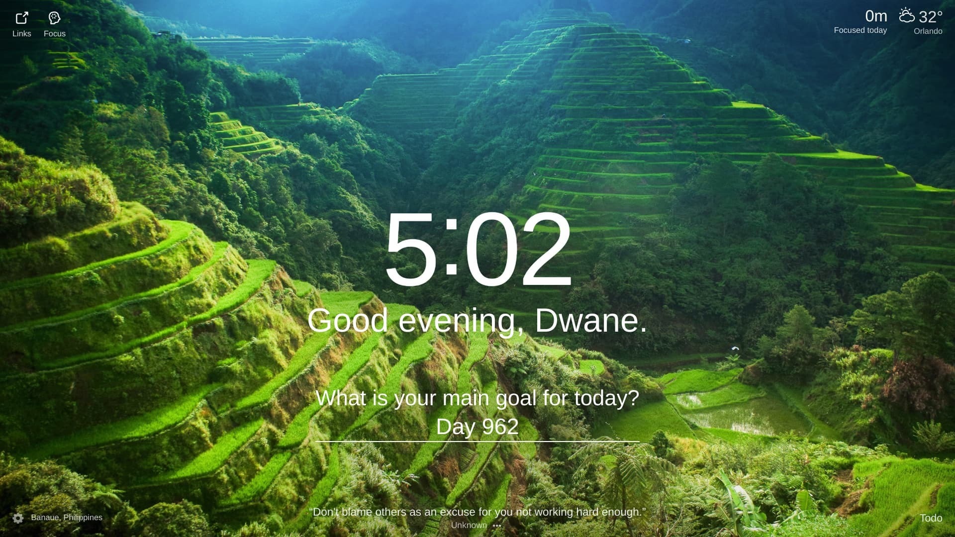 The photo shows a lush green valley with rice terraces in Banaue, Philippines. The terraces are built on the slopes of the mountains and are irrigated by a complex system of canals. The terraces are planted with rice, which is the staple food of the Philippines. The photo was taken from a high angle, which gives the viewer a panoramic view of the valley. The scene is one of peace and tranquility. The only sound is the gentle rustling of the wind through the rice plants.