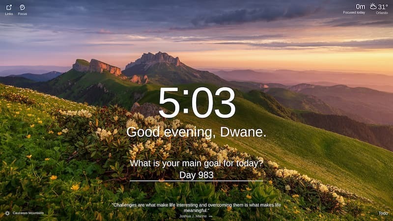 A photo of a mountain range with a beautiful sunset in the background. The mountains are rocky and jagged with some green grass and flowers growing on them. The sun is setting behind the mountains and is casting a golden light on the scene.
Location: Caucasian Mountains.