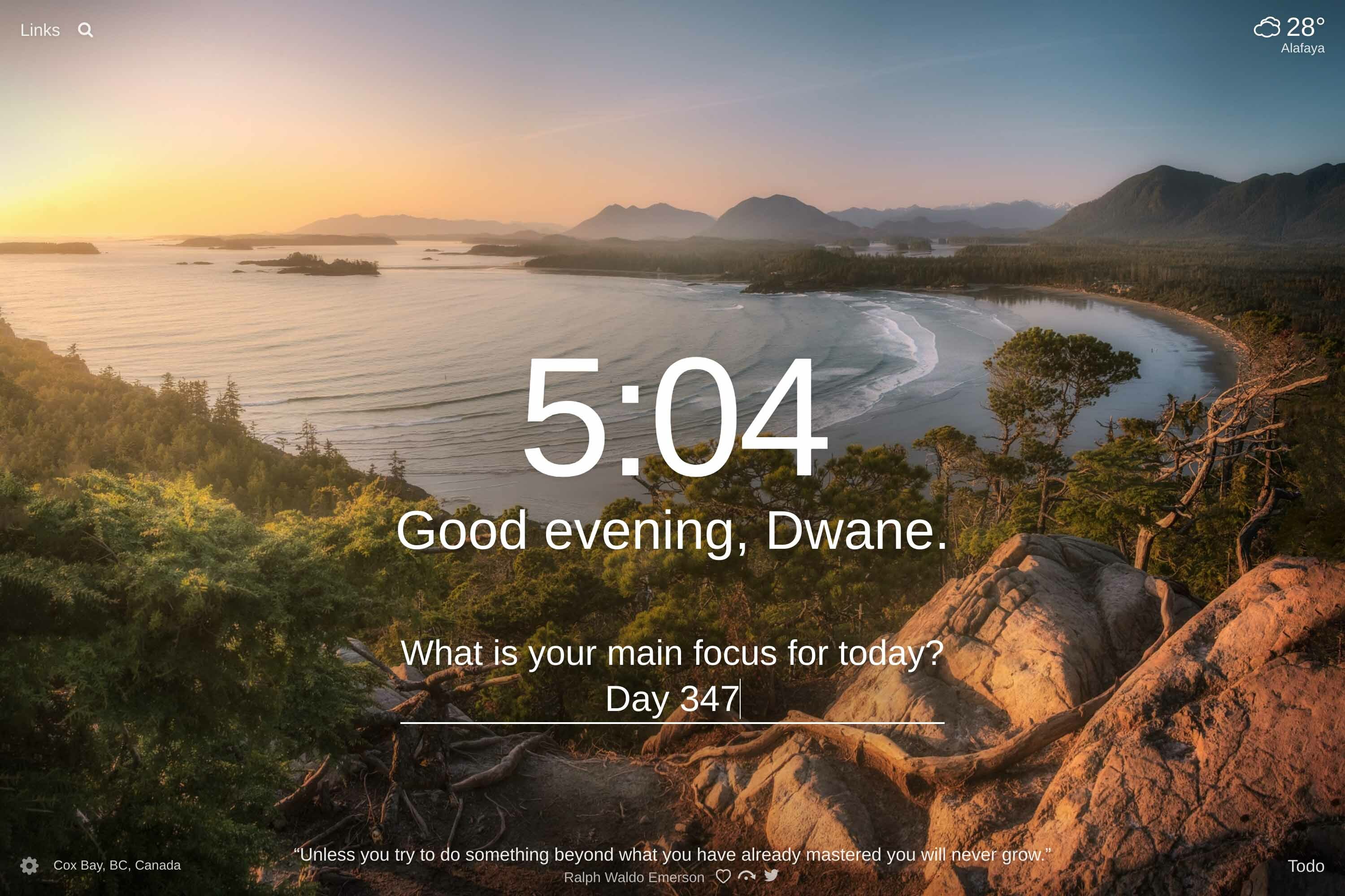 View into a cove surrounded my mountains at sunset in Cox Bay, BC, Canada