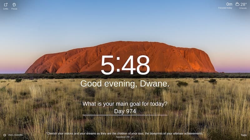 Uluru, also known as Ayers Rock, is a large rock formation in the Northern Territory of Australia. It is a UNESCO World Heritage Site and is one.6 kilometers long, 2.4 kilometers wide, and 348 meters high. The rock is surrounded by desert and is a popular tourist destination. The scenery in the picture is very beautiful. The rock is a stunning sight, and the desert landscape is very unique. The colors of the rock and of the most iconic landmarks in the country. The rock is made of sandstone and is over 300 meters high. It is surrounded by desert and is the sky are very vibrant, and the picture is very atmospheric. a popular destination for tourists. The photo shows Uluru in the background with a large grass field in front of it. The sky is a clear blue and there are some clouds in the distance. The sun is setting and the rock is glowing red. There is a tree in the foreground and some grass is growing in the field.