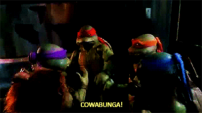 A clip from the old-school live action Teenage Mutant Ninja Turtles movies from the 90's... the turtles all give a four-way high five while saying "cowabunga!"