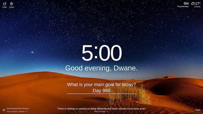 This is a picture of the Erg Chebbi sand dunes in Souss-Massa-Drâa, Morocco. The dunes are a popular tourist destination and offer a variety of activities, including hiking, sandboarding, and camel trekking. The orange dunes are located in the Sahara Desert and are surrounded by a vast expanse of sand. The night sky is clear and there are stars shining brightly.