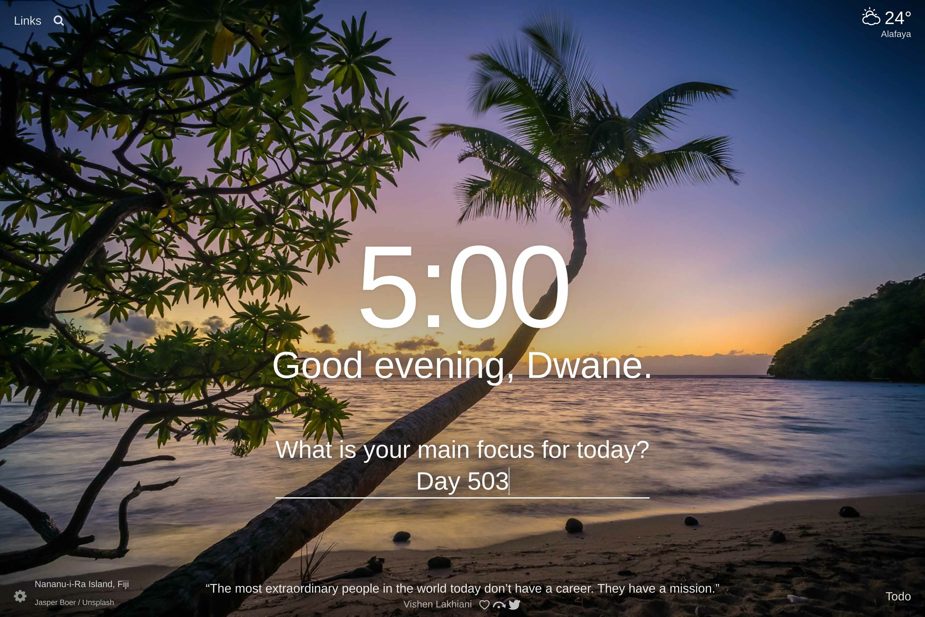View from a beach at sunset looking out into the ocean with a palm tree stretching out into the sea in Nananu-i-Ra Island, Fiji