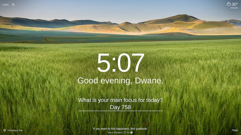 A field of tall grass in Campagna, Italy with hills in the distance