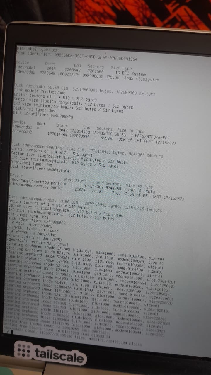 A Linux terminal displaying the output of the `e2fsck` command successfully clearing orphaned inodes and reporting the `/dev/sda2 `filesystem as clean.