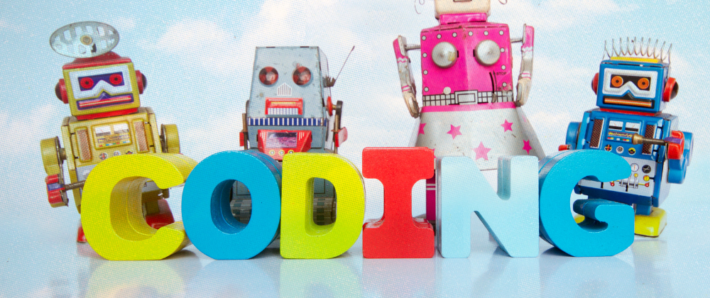 Toy robots beside 'CODING' blocks illustrating JavaScript learning